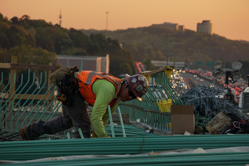 Alt-text: Following high-visibility clothing regulations and standards ensures the safety of workers such as this individual.